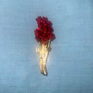 This is a gold rose bouquet brooch.